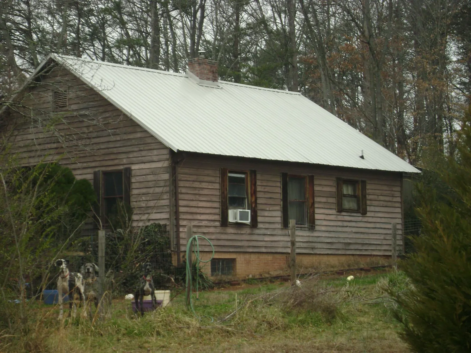 White metal roof on an old wood sided farmhouse, from a Metal Roof Installation job in Dunreith