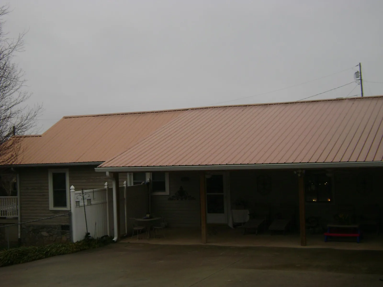 Copper toned metal roof over a wide covered patio in Dunreith